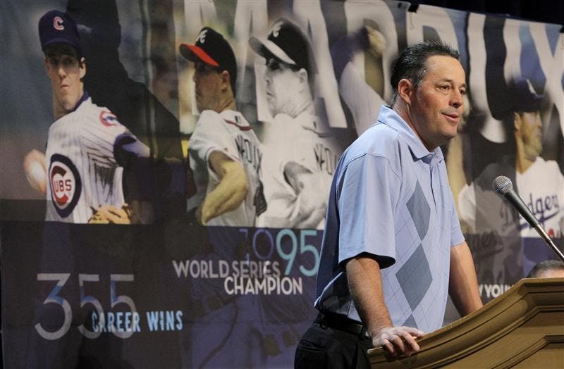 Four-time Cy Young winner Greg Maddux answers questions from the media after announcing his retirement at the baseball winter meetings Monday in Las Vegas.