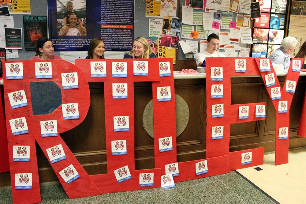 Claire Lechleiter, left, Hayley Webb and Jessi Wernsman hand out bracelets, tattoos, pins and information about Riley Hospital for Children during IUDM's Riley Week.