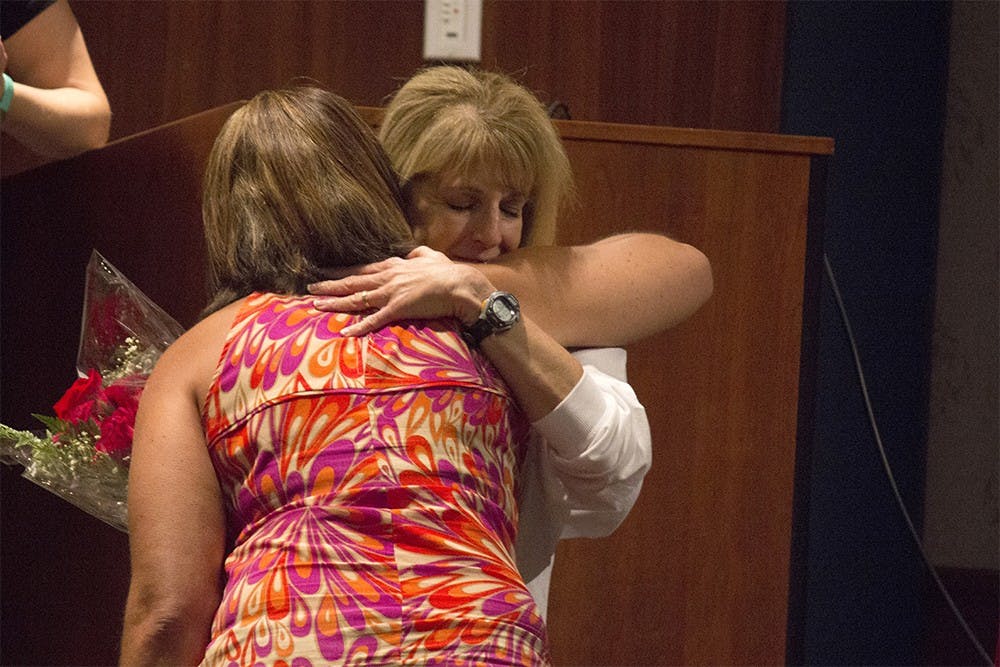 Jackie Daniels, director of Oasis, hugs Angi Fiege at the end of the Rachael's First Week program in Whittenberger Auditorium on Friday. Fiege formed the program after her daughter Rachael died during Welcome Week two years ago as a way of preventing tragedy from striking another family.
