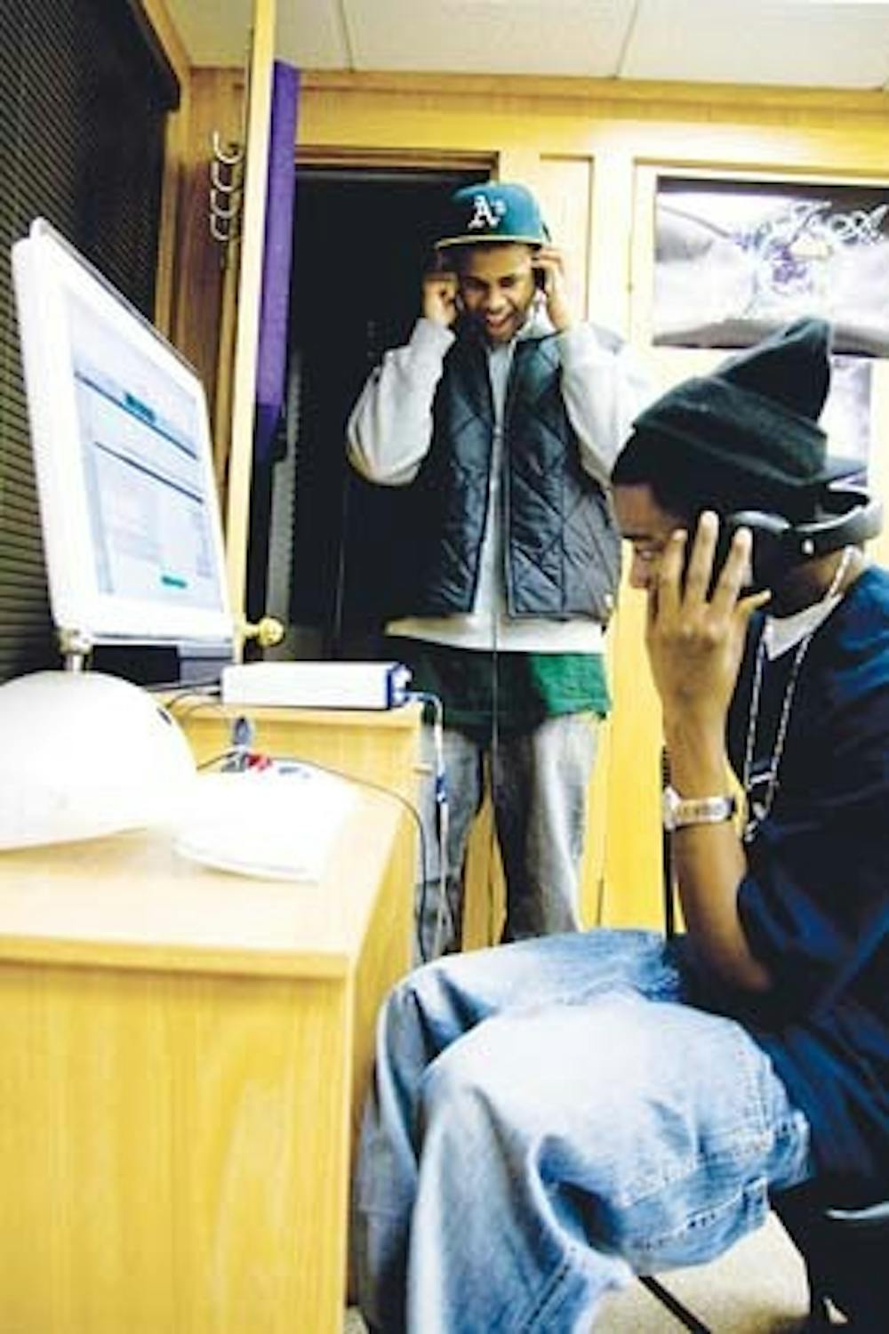 BFA President Joby Wright (background) and BFA artist Randell Hopkins, a.k.a. Lil’ 1, pictured at the BFA studios. BFA is not only dedicated to quality recording, it also helps artists who are seeking promotion, booking or marketing.  The BFA producers can edit the recorded music  or teach the artists how to do it themselves.