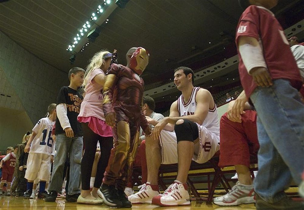 Senior forward Kyle Taber greets young Hoosier fans during the costume parade at halftime of the Cream and Crimson scrimmage Friday night at Assembly Hall.  The scrimmage was part of "Haunted Hall of Hoops" in which Hoosier fans were invited to meet the new coach and his players.