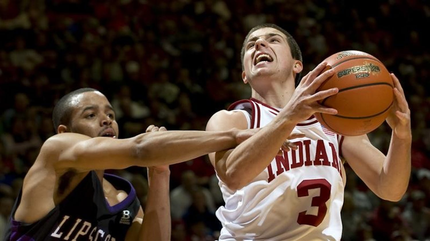 IU's Daniel Moore, right, is fouled by Lipscomb's Jimmy Oden while driving to the basket during the second half of the Hoosiers' game Sunday, Dec. 28, 2008. IU lost to the visiting Bisons, 74-69.