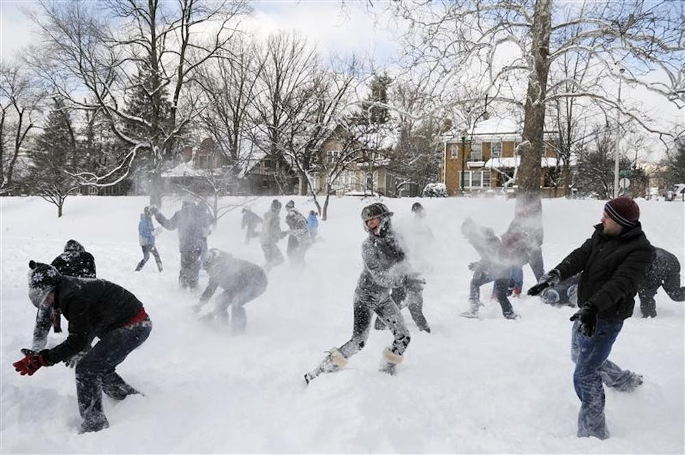 Student battle in a snow ball fight Wednesday in Dunn Meadow. IU canceled classes Wednesday due to snow, and Monroe County declared a state of emergency.