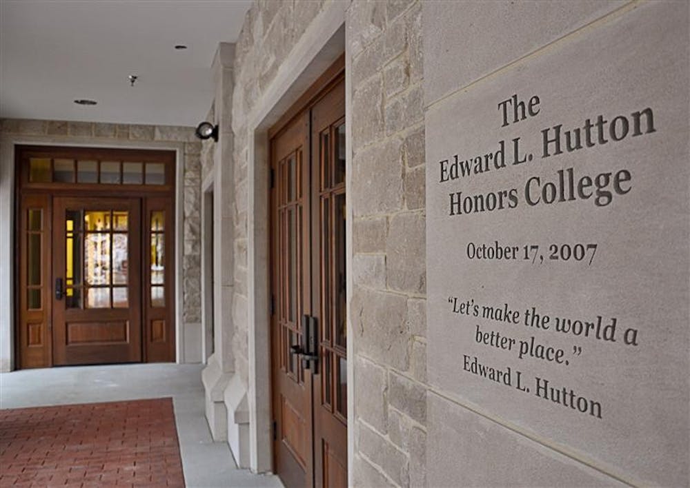 Edward L. Hutton encourages students and professors to "make the world a better place" as they approach the main entrance of the new Hutton Honors College.