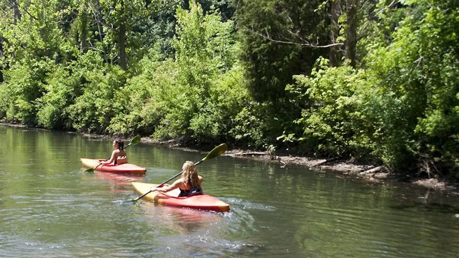 IU senior Kayla Rhodes and junior Amy DiMatteo paddle their kayaks away from shore at Griffey Lake on June 9th. The kayaks and canoes are available for rental from the Girffey Lake Boathouse for $6 per hour.