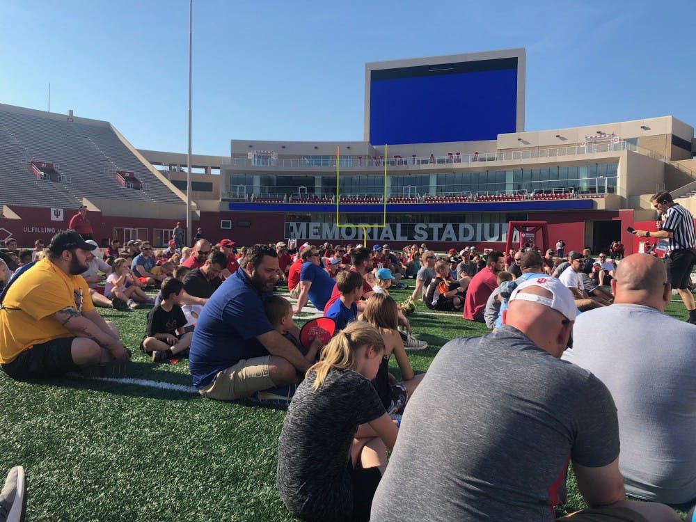 Children and fathers listen intently to IU Football Coach Tom Allen during the opening address of the All Pro Dad Experience on Saturday at Memorial Stadium.