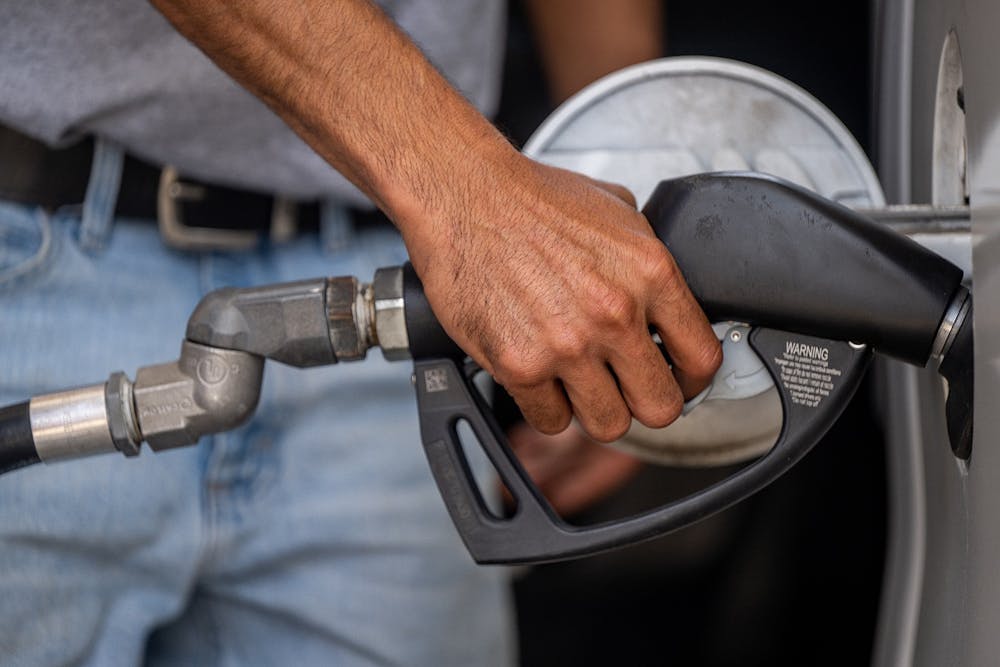 <p>Guy Benhamou pumps gas at an Exxon Mobil gas station on June 9, 2022, in Houston, Texas. The Indiana gasoline tax will go up one cent to 34 cents a gallon beginning July 1,</p>
