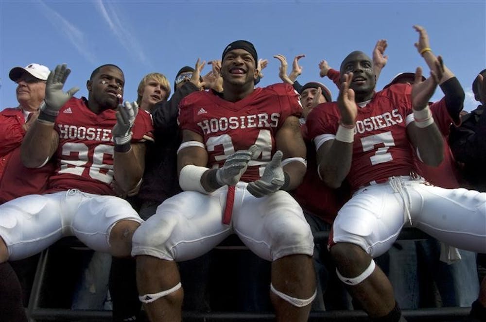 Senior safety Brandon Mosley, junior linebacker Will Patterson, and junior wide receiver Ray Fisher join students in the stands to celebrate the 21-19 victory over Northwestern Saturday at Memorial Stadium.  The Homecoming win ended a five game losing streak for the Hoosiers.