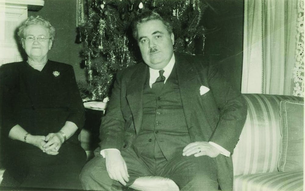 Herman B Wells with his mother, Anna Bernice Harting Wells, in the front room of Woodburn House about 1950.  Wells served IU in many capacities including as the Univeristy's 11th president and long-time chancellor.  
