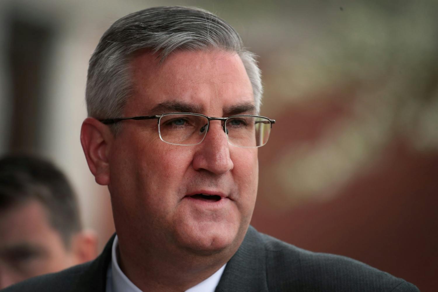 Indiana Gov. Eric Holcomb addresses the media after meeting with former residents and taking a brief tour of the West Calumet Housing Complex with EPA Administrator Scott Pruitt on April 19, 2017, in East Chicago, Indiana. The Associated Press has called the Indiana governor race for Eric Holcomb on Tuesday.