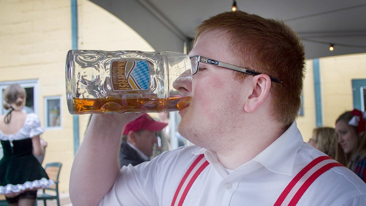 Keenan Hartment drinks beer at the Upland Brewing Company's Oktoberfest event Saturday.