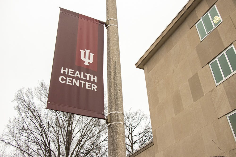 <p>An IU Health Center sign hangs on a pole along North Jordan Avenue. Students living on campus can self-isolate in IU-owned off-campus houses while being tested for the coronavirus.</p>