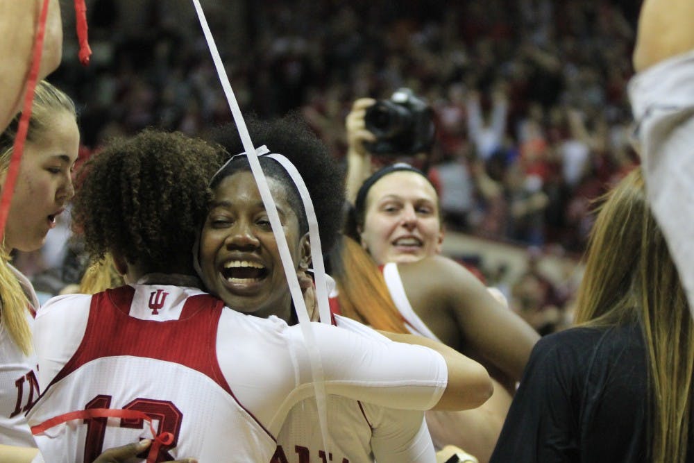 <p>Team members Keyanna Warthen and Jaelynn Penn hug after winning their last game of the season and the WNIT. The team will raise its championship banner at Hoosier Hysteria on Saturday.&nbsp;</p>