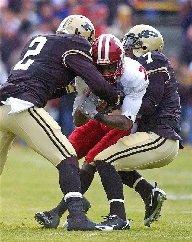 Junior wide receiver Ray Fisher goes down as safety-cornerbacks Torri Williams and Brandon King of Purdue strip the ball out to cause a fumble Saturday in West Lafayette.  The Hoosiers fumbled the ball three times during the 62-10 loss of the Old Oaken Bucket game.