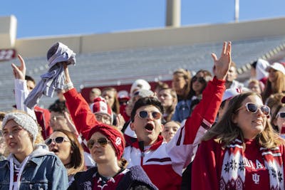 An IU football fan cheers after catching a free shirt before a football game Oct. 12, 2019, in Memorial Stadium. Big Ten fall sports were postponed Aug. 11 until the spring semester.