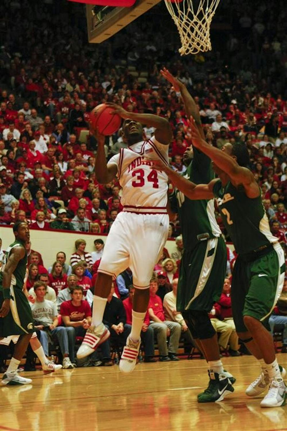 Freshman Guard/Forward Malik Story goes for a basket against a Michigan State defender Tuesday evening at Assembly Hall. The Hoosiers lost to Michigan State with a final score of 59-64.