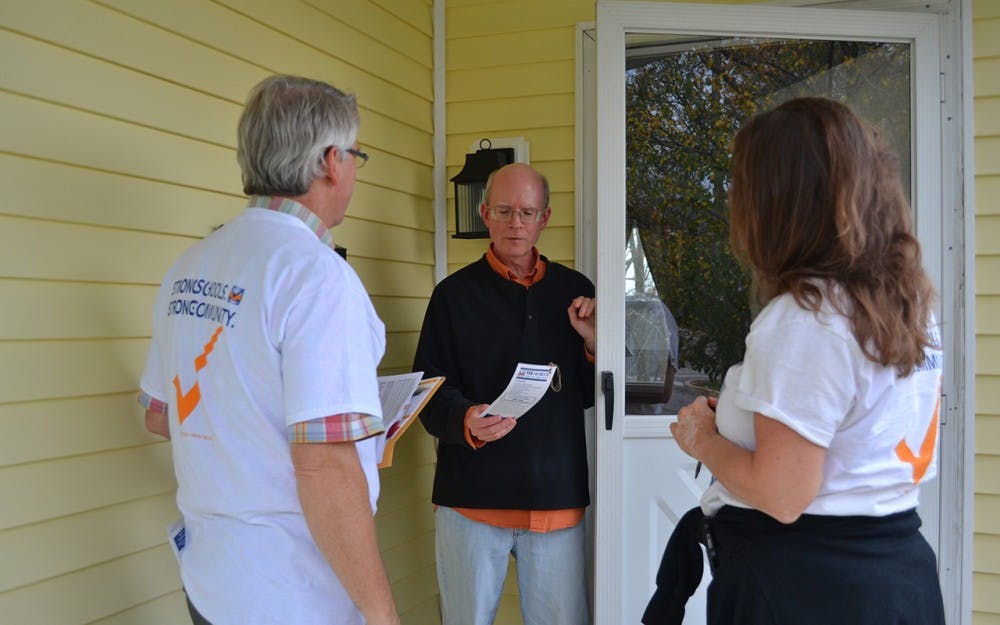 Mayor John Hamilton and schoolboard candidate Cathy Fuentes-Rohwer canvas and talk to voters about the referendum Wednesday night.