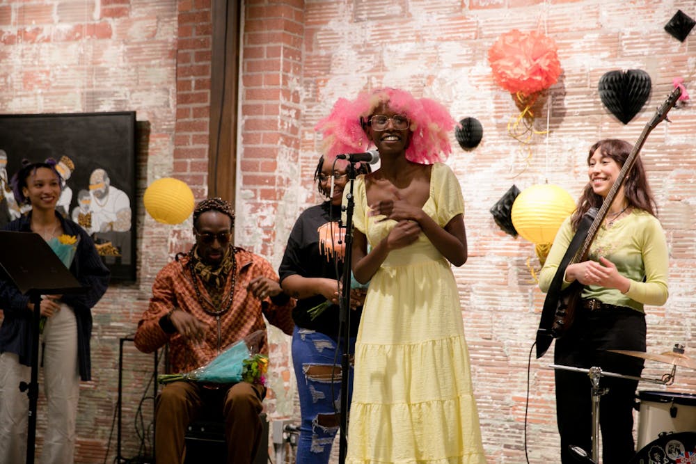 <p>Jae Gasana addresses the crowd after handing performers flowers for the GRB Open Mic Night on Feb. 25, 2023,  at the FAR Center of Contemporary Art. Girls Rock Bloomington and the FAR Center for Contemporary Arts hosted a Black History Month open mic night at 6 p.m. on Feb. 25, 2023. </p>