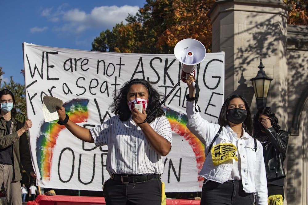 <p>Senior Ruby Flores Camacho and junior Evelyn Sanchez stand together and give a speech during the Unite To Ignite rally Oct. 16 in front of the Sample Gates.</p>