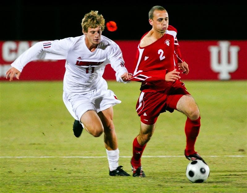 Sophomore midfielder Rich Balchan is held by Louisville's Brent Rosendall while moving the ball upfield during the Hoosiers 1-0 win over the Cardinals Wednesday night a Bill Armstrong Sadium.