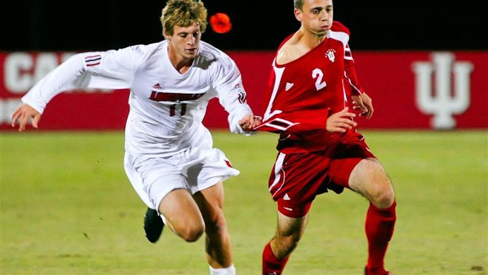 Sophomore midfielder Rich Balchan is held by Louisville's Brent Rosendall while moving the ball upfield during the Hoosiers 1-0 win over the Cardinals Wednesday night a Bill Armstrong Sadium.