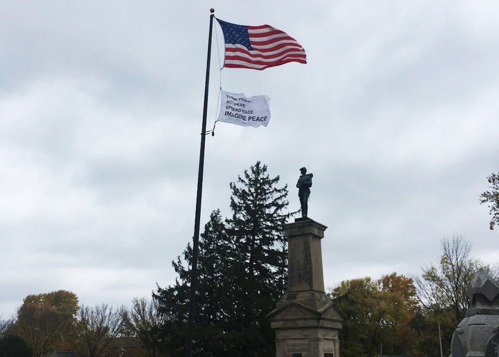 <p>A flag waves in Rosehill Cemetery as part of Bloomington's participation in a national public art collaboration called "Pledges of Allegiance." The flag, created by multimedia artist Yoko Ono, is the sixth flag in the series of 16 flags.&nbsp;</p>