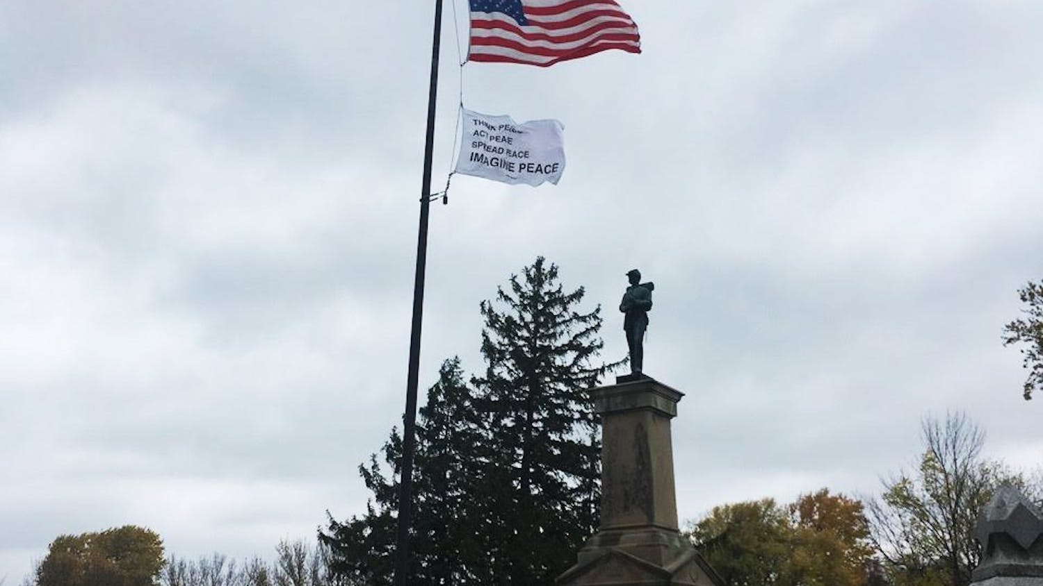 A flag waves in Rosehill Cemetery as part of Bloomington's participation in a national public art collaboration called "Pledges of Allegiance." The flag, created by multimedia artist Yoko Ono, is the sixth flag in the series of 16 flags.&nbsp;