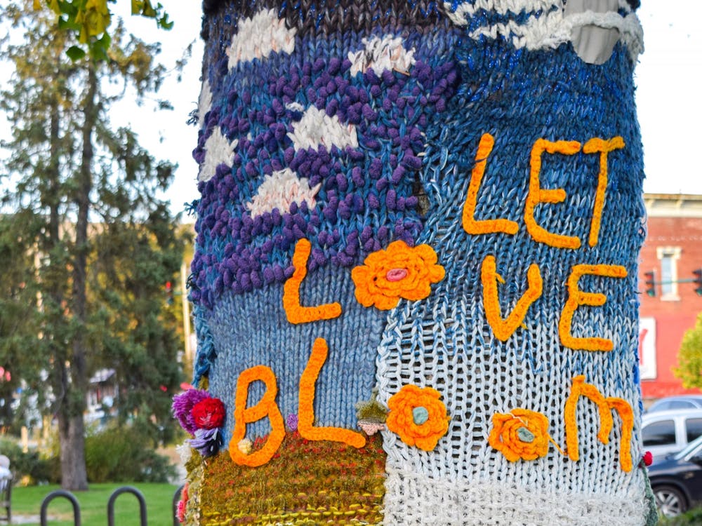 A tree wrapping is seen Oct. 1, 2021, at 100 W. Kirkwood Ave. The wrapping was sponsored by Anna Strout in memory of late Middle Way House executive director Toby Strout and created by resuing previous wrappings by fabric artists Toby Strout, Meg Prince and Donna Storm.