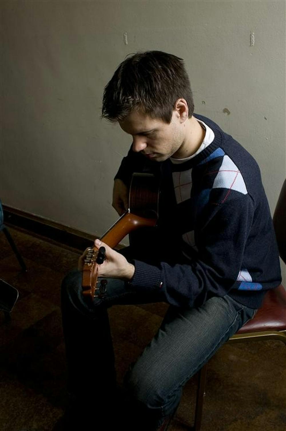 IU Jacobs School of Music graduate student Nemanja Ostojic tunes his guitar in his studio Friday afternoon in Merril Hall before teaching a lesson. Ostojic won first place at the Southwest Guitar Festival in San Antonio, Texas in February.  