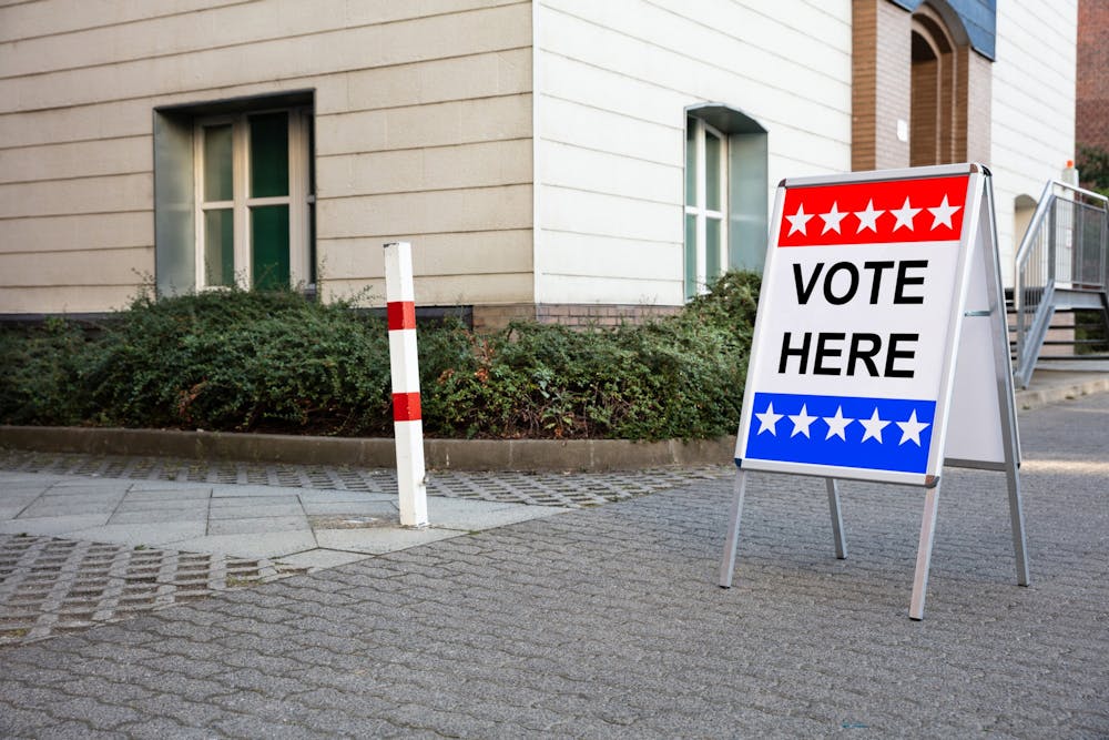 A sign that reads "vote here" is seen outside a polling place in Miami-Dade County in Florida.