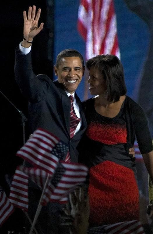 Sen. Barack Obama, D-Ill., waves to the crowd with his wife, Michelle, after it was announced that Obama would win the presidency Tuesday night in Grant Park in Chicago.