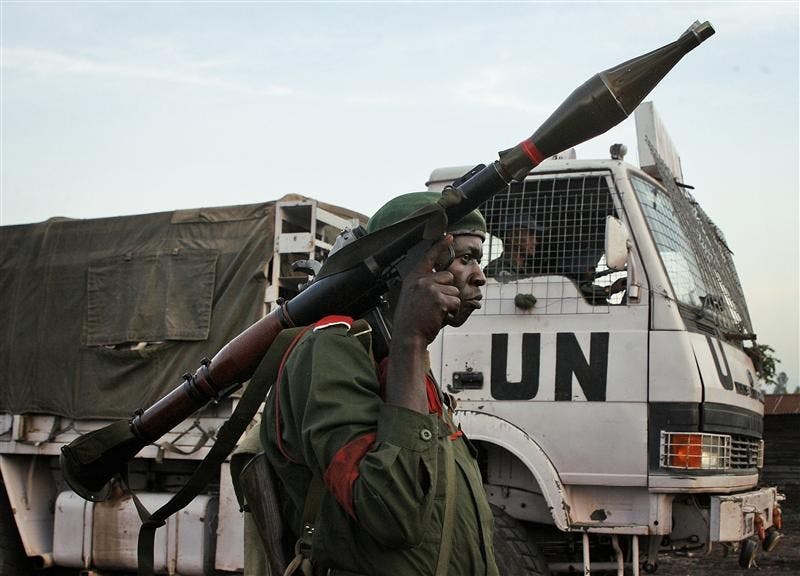 A Congolese government soldier (FARDC) stands guard by a UN truck on Sunday at the Kibati checkpoint north of Goma, eastern Congo.  Government forces stopped a UN convoy they claim was infiltrated by CDNP rebels in Goma, and took them into custody. UN officials say they were transporting 10 Mai Mai militiamen who had surrendered to the UN demobilization program.