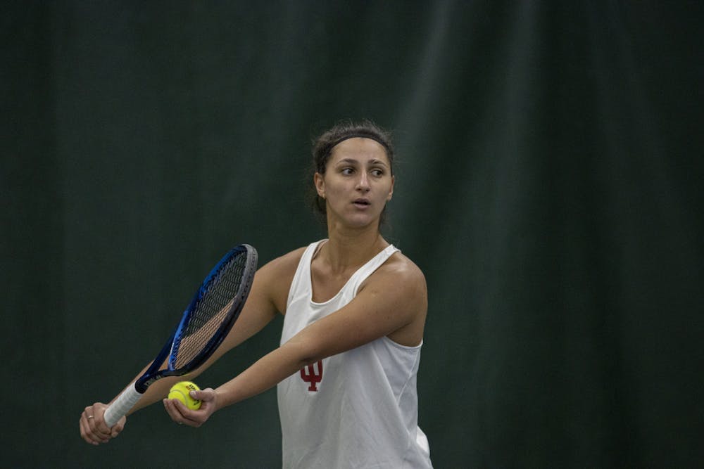 <p>Junior Alexandra Staiculescu prepares to serve in her singles match against Nebraska on March 27, 2022, at the IU Recreational Sports Tennis Center. Indiana faced the No. 51 ranked Nebraska Cornhuskers on Sunday.</p>
