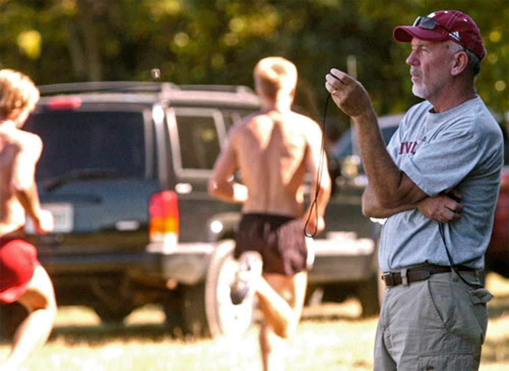 Director and head coach Ron Helmer times members of the IU track team during practice September 7, 2007 at the IU Cross Country Course.