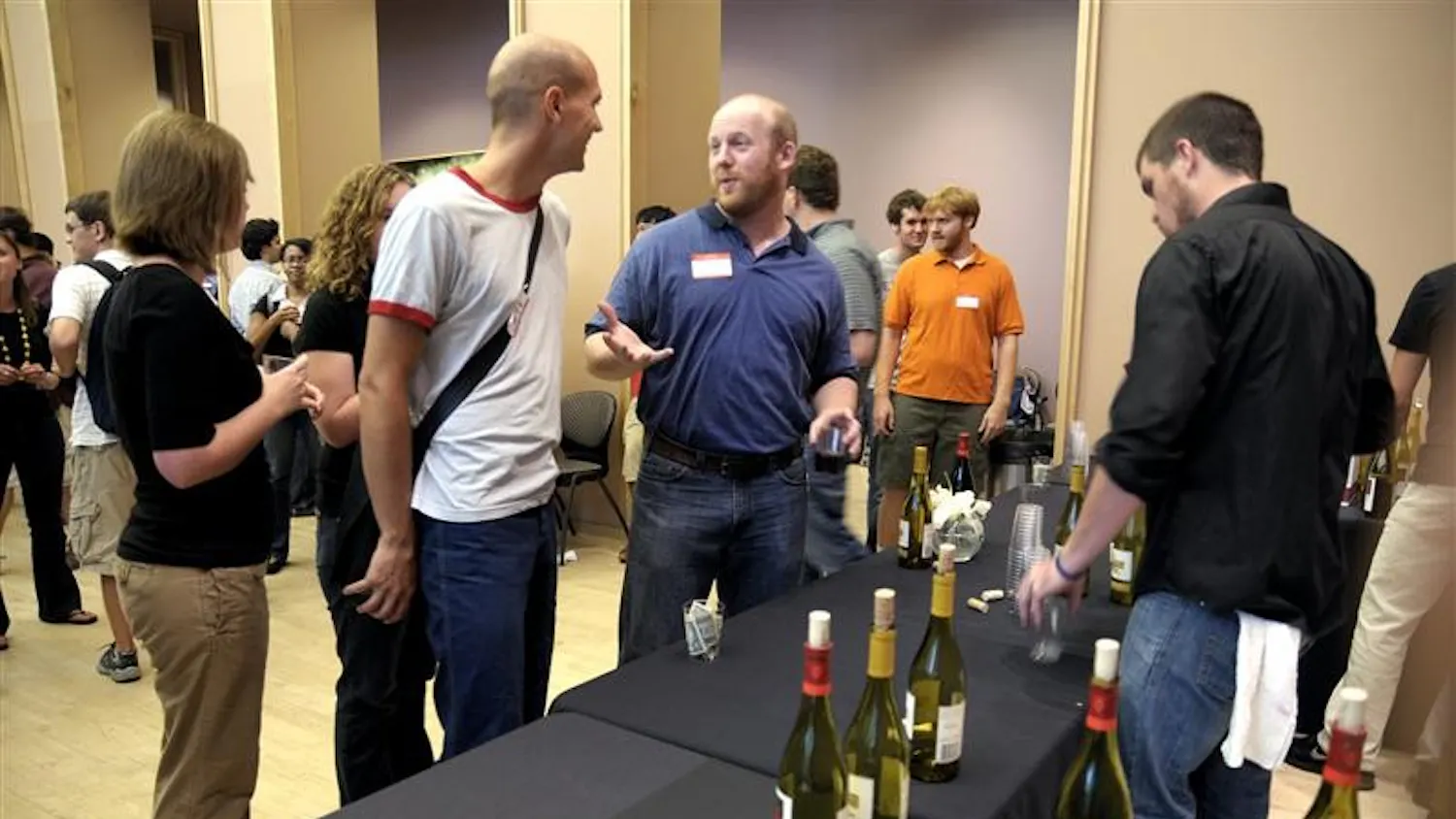 Dan Smith, an employee of Lennie's, serves wine at the University Graduate School reception to welcome back new and returning graduate students at the Neal-Marshall Center Friday afternoon. Lennie's donated wine and labor to the event.