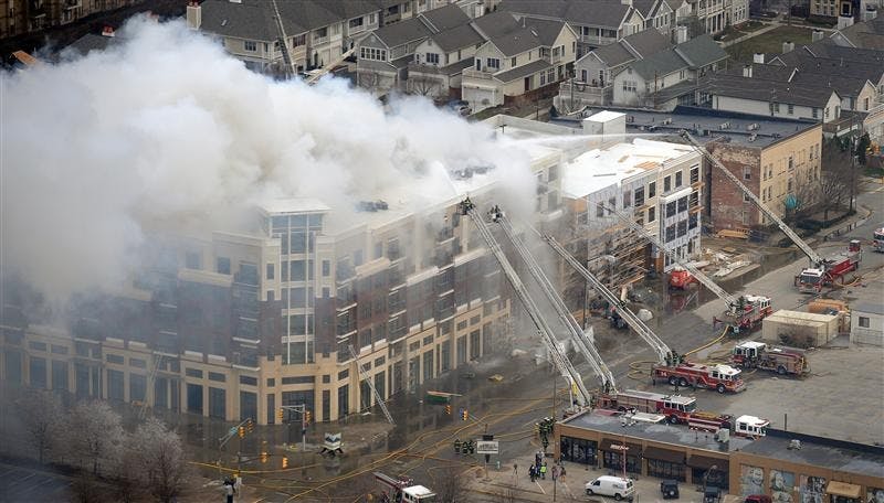 Members of the Indianapolis Fire Department work to put out a large fire at the Cosmopolitan on the Canal complex in downtown Indianapolis on Thursday, March 12, 2009.