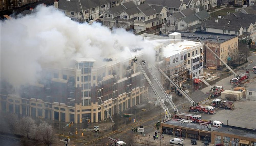 Members of the Indianapolis Fire Department work to put out a large fire at the Cosmopolitan on the Canal complex in downtown Indianapolis on Thursday, March 12, 2009.
