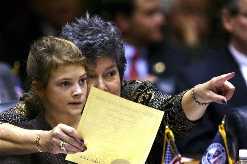 Rep. Cindy Noe, R-Indianapolis, points to the front of the House of Representatives with her granddaughter, Claire Nieshalla, 7, as the Indiana House begins business on Organization Day on Tuesday at the Statehouse in Indianapolis. Among the issues legislators are expected to tackle when the next session gets underway in January are the budget, property tax caps and education funding.