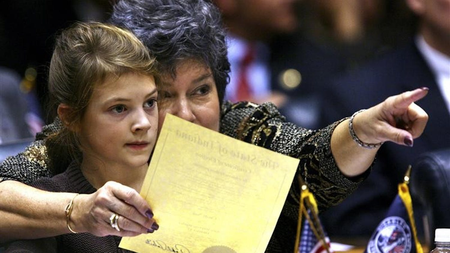 Rep. Cindy Noe, R-Indianapolis, points to the front of the House of Representatives with her granddaughter, Claire Nieshalla, 7, as the Indiana House begins business on Organization Day on Tuesday at the Statehouse in Indianapolis. Among the issues legislators are expected to tackle when the next session gets underway in January are the budget, property tax caps and education funding.