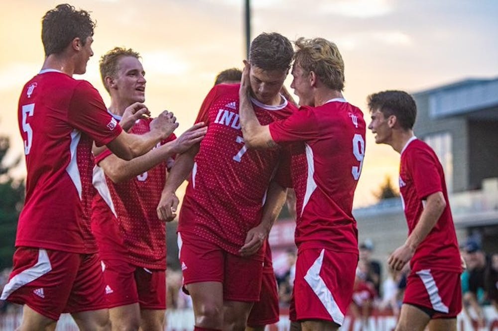 <p>Teammates of Junior Victor Bezerra celebrate after he scores a goal against the University of Louisville Aug. 21 at Bill Armstrong Stadium. IU finished the preseason with a 2-0-1 record after beating Louisville 5-4.</p>