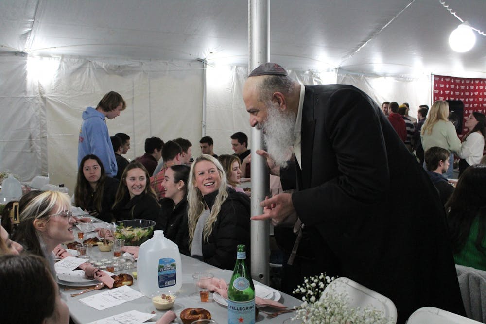 <p>A member of Chabad at IU speaks with guests during a large Shabbat gathering Dec. 9, 2022, in Dunn Meadow. The Shabbat service drew in over 500 guests.</p>