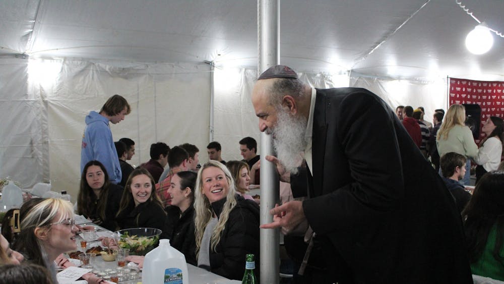 A member of Chabad at IU speaks with guests during a large Shabbat gathering Dec. 9, 2022, in Dunn Meadow. The Shabbat service drew in over 500 guests.