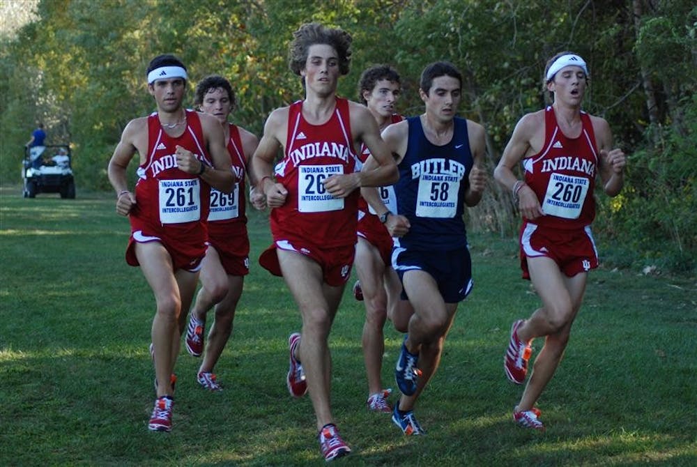 Sophomore Andrew Poore (center) leads a pack of Hoosiers and Butler's Rob Mullett at Indiana Intercollegiates on Friday evening in Terre Haute. Poore finished second behind Mullett, and the Hoosiers took the next four places to finish first as a team.