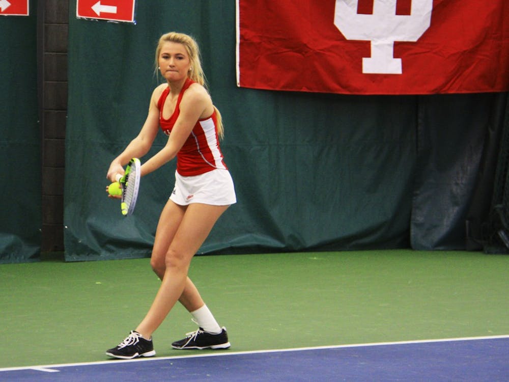 Then-sophomore, now senior Madison Appel serves the ball during a women's tennis doubles match against West Virginia in March 2017.&nbsp;