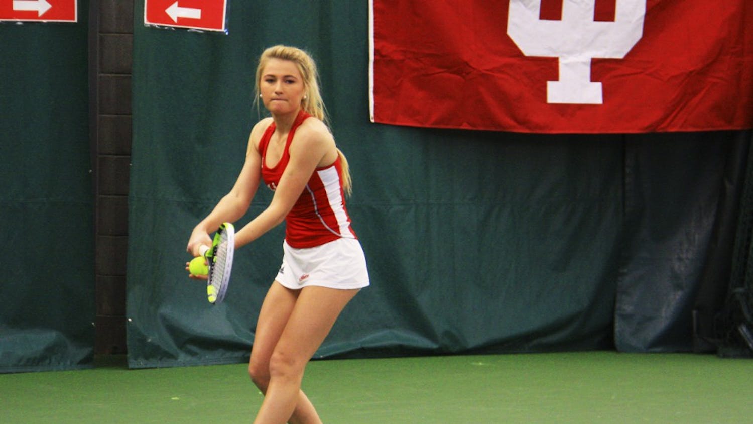 Then-sophomore, now senior Madison Appel serves the ball during a women's tennis doubles match against West Virginia in March 2017.&nbsp;