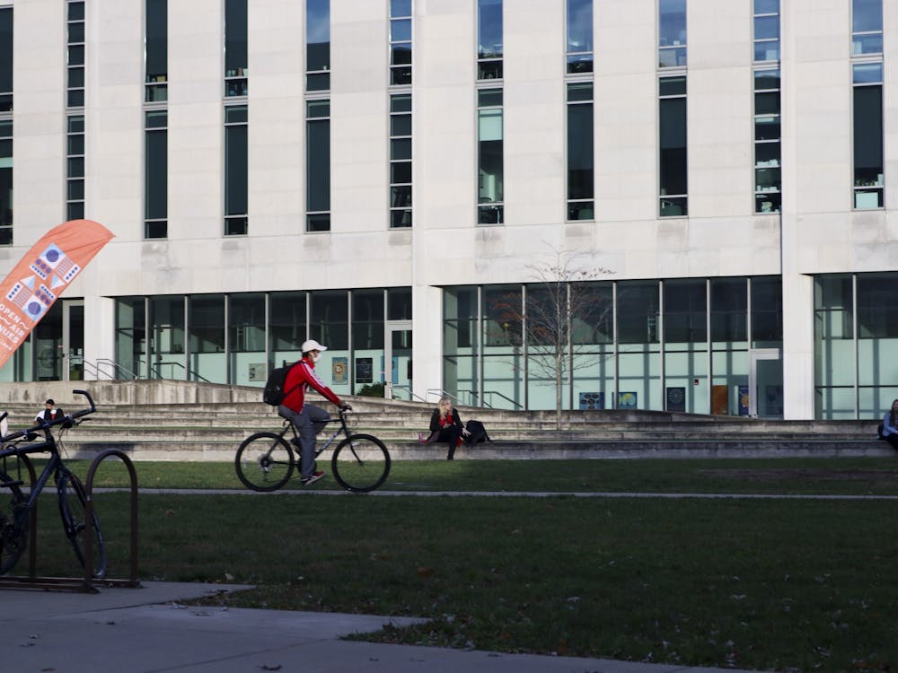A student rides his bike Nov. 8, 2021, near the Hamilton Lugar School of Global and International Studies. Transportation Demand Management is partnering with the Crimson Cupboard Food Pantry during the Thanksgiving season in a new initiative called the Kindness Commute Campaign.
