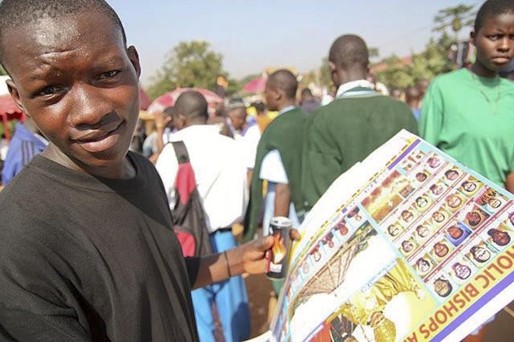 A boy sells posters with the faces of Ugandan Catholic bishops June 3. 