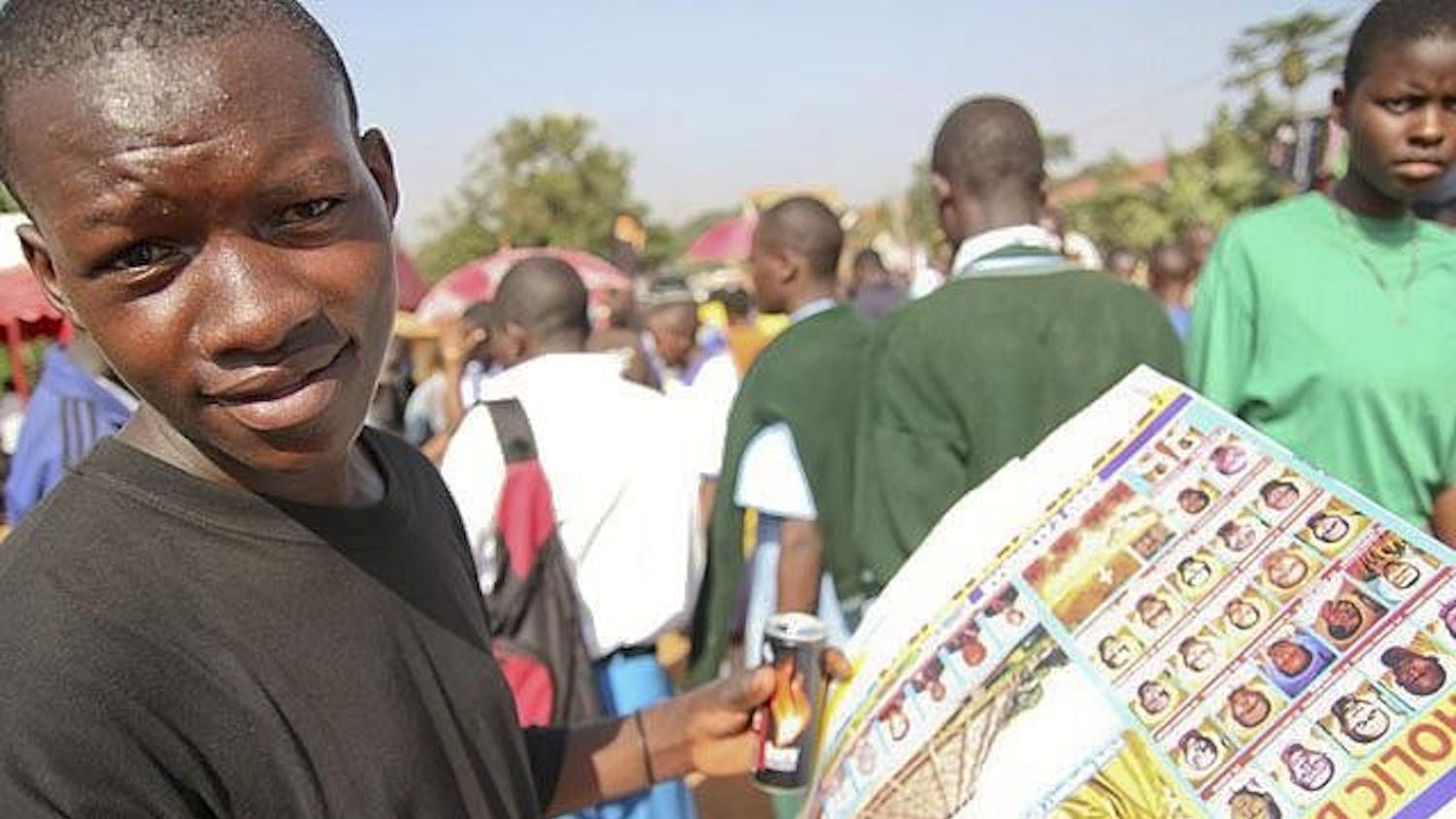 A boy sells posters with the faces of Ugandan Catholic bishops June 3.
