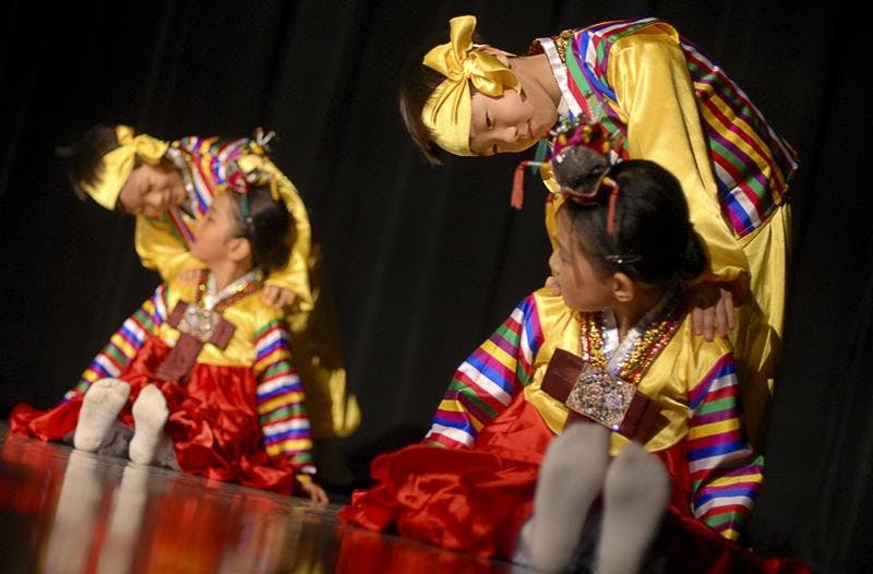 Korean School students Yu Yeul Kwak, Won Yong Park, Hanam Kim, and Jae In Lee perform the Kokdukagssi dance during Korean Night Saturday evening in the Willkie Auditorium. The children learned the traditional dance in 6 weeks.