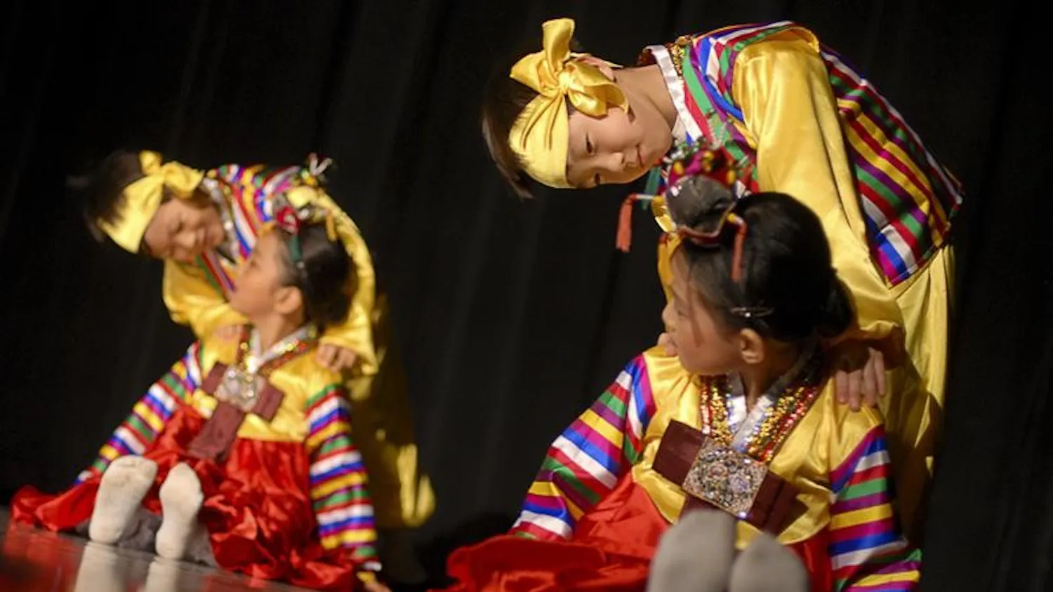 Korean School students Yu Yeul Kwak, Won Yong Park, Hanam Kim, and Jae In Lee perform the Kokdukagssi dance during Korean Night Saturday evening in the Willkie Auditorium. The children learned the traditional dance in 6 weeks.